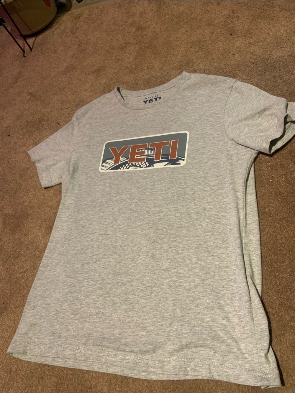 Yeti Light Gray Tee with Orange and Blue Fish print Logo